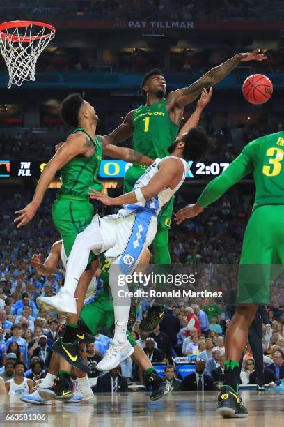 Joel Berry II of the North Carolina Tar Heels goes up with the ball against Tyler Dorsey and Jordan Bell of the Oregon Ducks in the second half...