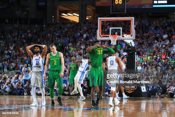 Casey Benson and Dylan Ennis of the Oregon Ducks react after being defeated by the North Carolina Tar Heels during the 2017 NCAA Men's Final Four...