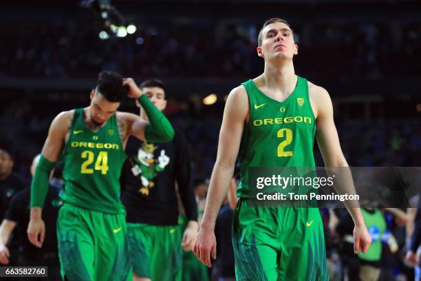 Dillon Brooks and Casey Benson of the Oregon Ducks walk off the court after being defeated by the North Carolina Tar Heels during the 2017 NCAA Men's...