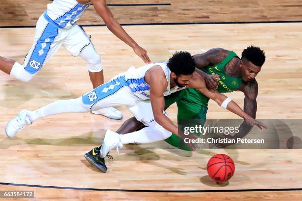 Joel Berry II of the North Carolina Tar Heels and Jordan Bell of the Oregon Ducks compete for a loose ball in the second half during the 2017 NCAA...