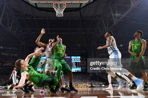 Casey Benson of the Oregon Ducks falls backwards as players look for a rebound during the 2017 NCAA Photos via Getty Images Men's Final Four...