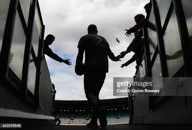 Nathan Jones of the Demons high fives fans as he comes out onto the field during the round two AFL match between the Melbourne Demons and the Carlton...