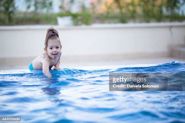 cute girl enjoying water in the swiming pool - 2 girls 1 sandbox stock pictures, royalty-free photos & images