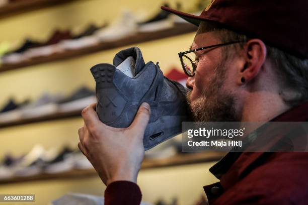 New KAWS x Air Jordan IV sneakers buyer kisses his shoe during the sale at "Overkill" sneakers store on March 31, 2017 in Berlin, Germany. Several...