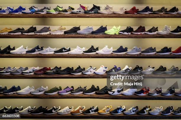 Shoes are seen at "Overkill" sneakers store on March 31, 2017 in Berlin, Germany during sale of New KAWS x Air Jordan IV sneakers. Several dozen...