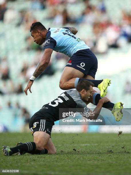 Israel Folau of the Waratahs is tackled by Tim Bateman of the Crusaders during the round six Super Rugby match between the Waratahs and the Crusaders...