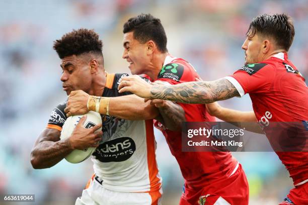 Kevin Naiqama of the Tigers is tackled during the round five NRL match between the Wests Tigers and the St George Illawarra Dragons at ANZ Stadium on...