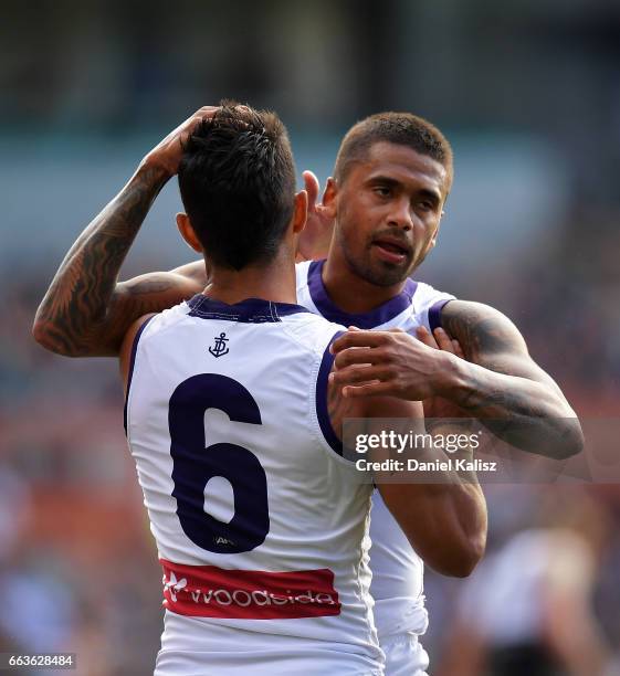 Danyle Pearce of the Dockers is congratulated by Bradley Hill of the Dockers after kicking a goal during the round two AFL match between the Port...