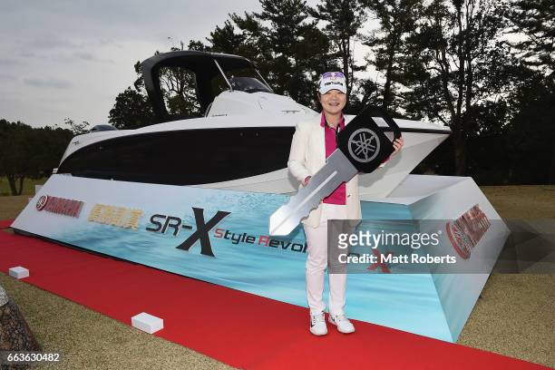 Min-Young Lee of Korea poses for a photograph after winning the final round of the YAMAHA Ladies Open Katsuragi at the Katsuragi Golf Club Yamana...
