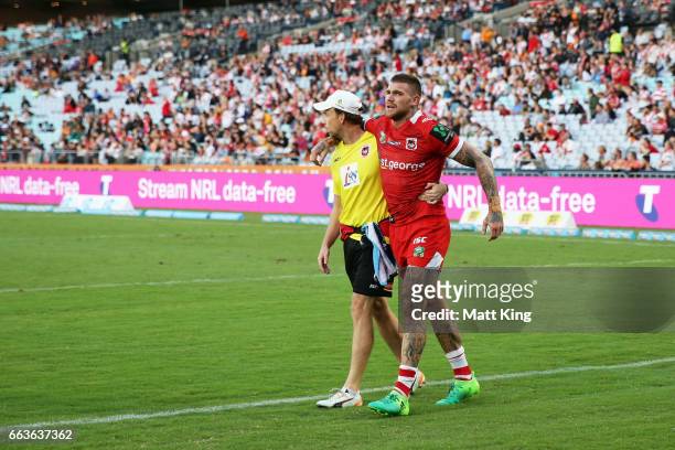 Josh Dugan of the Dragons is assisted from the field after sustaining an injury during the round five NRL match between the Wests Tigers and the St...