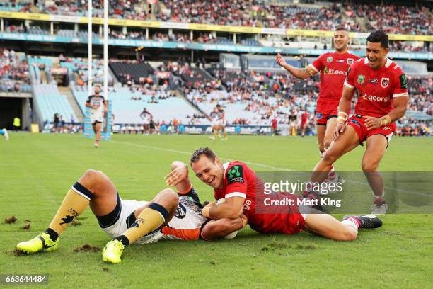 Jason Nightingale of the Dragons beats David Nofoaluma of the Tigers to score a try during the round five NRL match between the Wests Tigers and the...