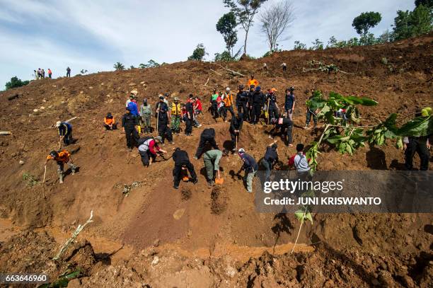 Indonesian rescuers search for survivors after a wall of mud slammed onto houses from a hillside after heavy rainfall in Ponorogo district, East Java...