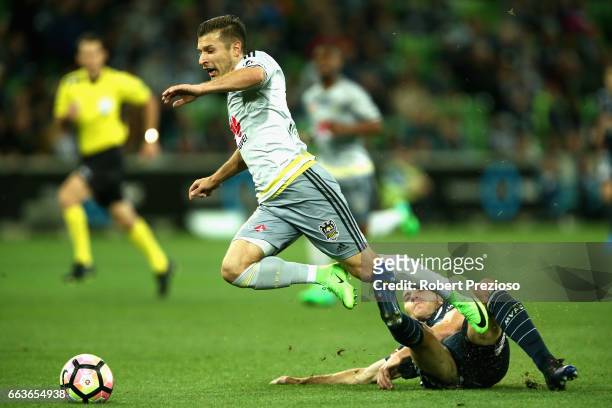 Alan Baro of the Victory receives a red card after applying this tackle on Kosta Barbarouses of the Phoenix during the round 25 A-League match...