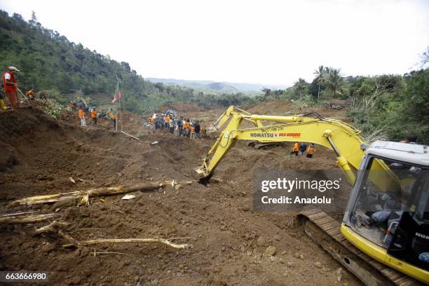 Rescue team search for more than two dozen people who were missing after a rain-triggered landslide struck a village in Ponorogo, East Java,...