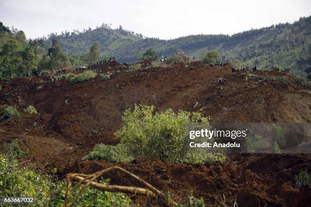 Rescue team search for more than two dozen people who were missing after a rain-triggered landslide struck a village in Ponorogo, East Java,...