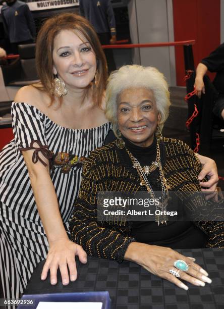 Actresses Marina Sirtis and Nichelle Nichols of 'Star Trek' sign autographs at the Sci-Fi Hollywood Museum booth on Day 2 of WonderCon 2017 held...