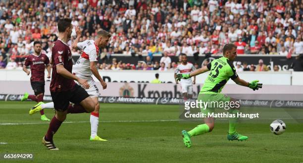 Simon Terodde of Stuttgart shoots past Marvin Schwäbe of Dresden to score his team's first goal during the Second Bundesliga match between VfB...