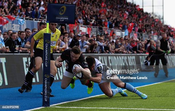 Chris Ashton of Saracens is tackled by Lee Jones of Glasgow Warriors to deny Saracens a try during the European Rugby Champions Cup match between...