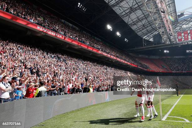 David Neres of Ajax celebrates scoring his teams second goal of the game with team mates during the Dutch Eredivisie match between Ajax Amsterdam and...