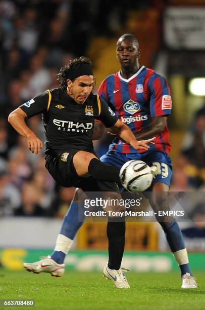 Manchester City's Carlos Tevez and Crystal Palace's Alassane N'Diaye battle for the ball
