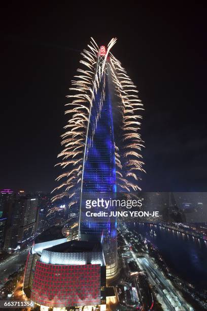 This general view shows fireworks on the Lotte World Tower to celebrate its opening in Seoul on April 2, 2017. Lotte World Tower, a 123-floor and...