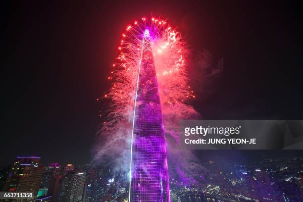 This general view shows fireworks on the Lotte World Tower to celebrate its opening in Seoul on April 2, 2017. Lotte World Tower, a 123-floor and...