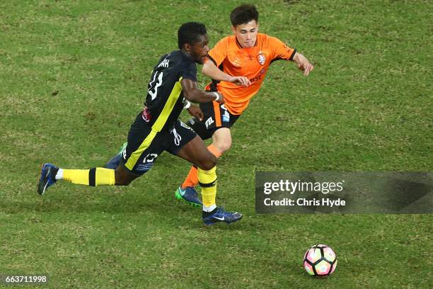 Joe Caletti of the Roar and Kwabena Appiah-Kubi of the Mariners compete for the ball during the round 25 A-League match between the Brisbane Roar and...