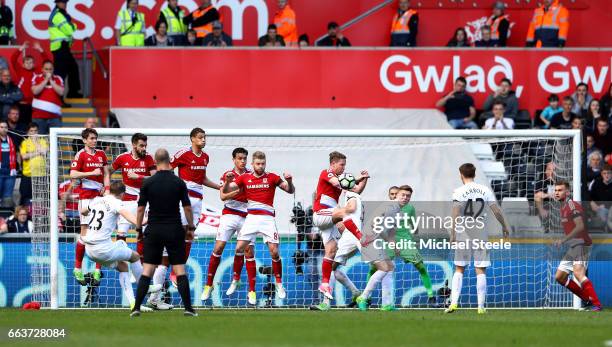 Gylfi Sigurdsson of Swansea City has his freekick blocked by Adam Forshaw of Middlesbrough during the Premier League match between Swansea City and...