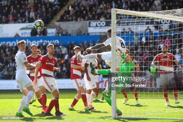 Leroy Fer of Swansea City attempts to head towards goal but colides with Victor Valdes of Middlesbrough during the Premier League match between...