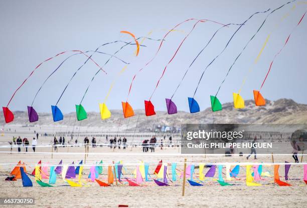 People fly kites in Berck-sur-Mer, northern France, on April 2, 2017 during the 31th International Kite Festival , which runs from April 1 to April 9.