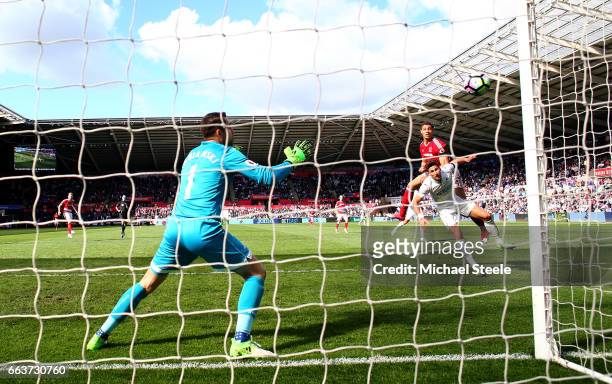 Rudy Gestede of Middlesbrough heads towards goal but his shot goes wide during the Premier League match between Swansea City and Middlesbrough at the...