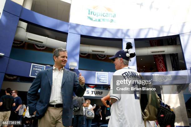 Tampa Bay Rays owner Stuart Sternberg greets baseball fans as they arrive for the first game of the season on Opening Day before the start of a game...