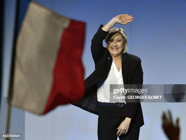 French presidential election candidate for the far-right Front National party Marine Le Pen waves as she arrives on stage to give a speech during a...