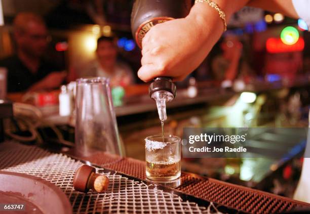 Shot of tequila is poured September 28, 2000 at La Hacienda in El Paso, Texas. Up to 40 percent of the firms making Mexico's tequila may halt...