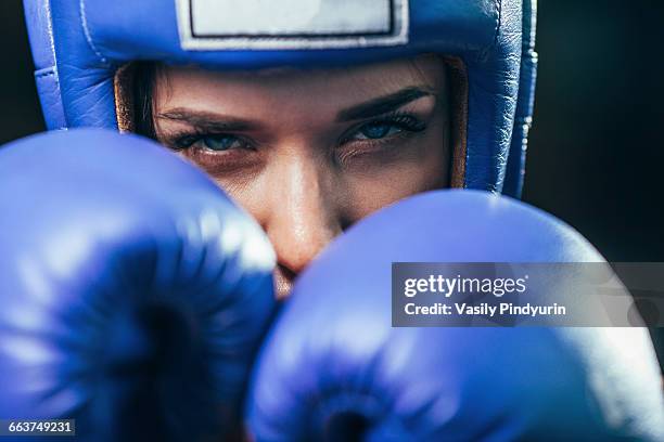 close-up portrait of confident female boxer - purple glove stock-fotos und bilder