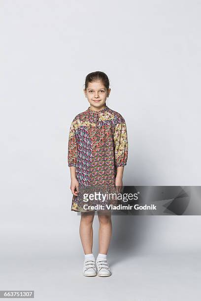 portrait of smiling girl standing against white background - girl who stands stock pictures, royalty-free photos & images
