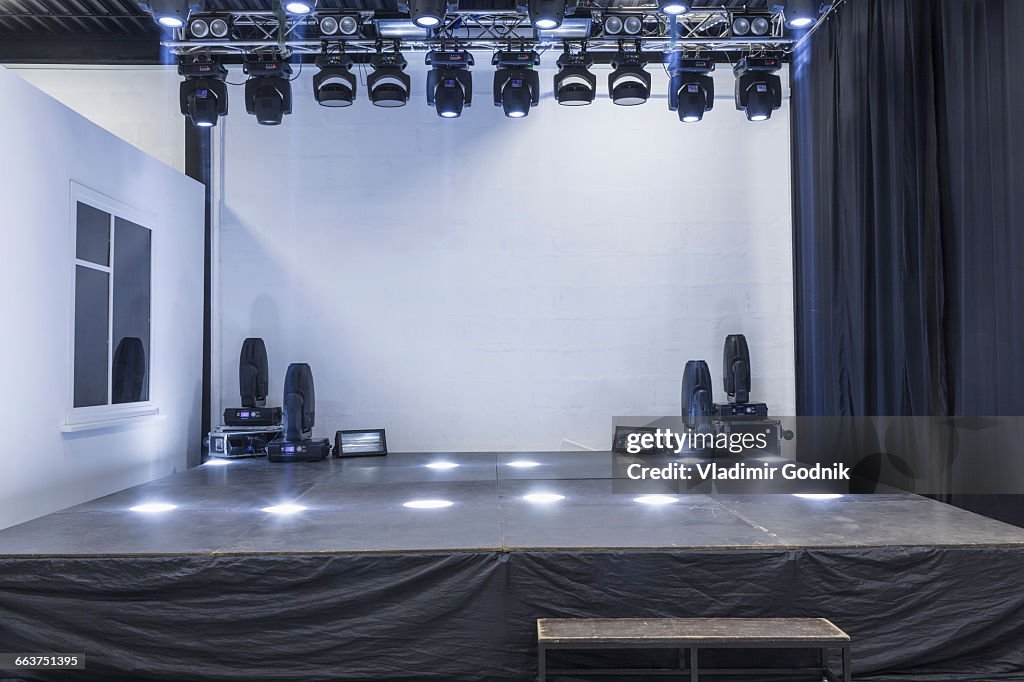 Illuminated empty stage in studio