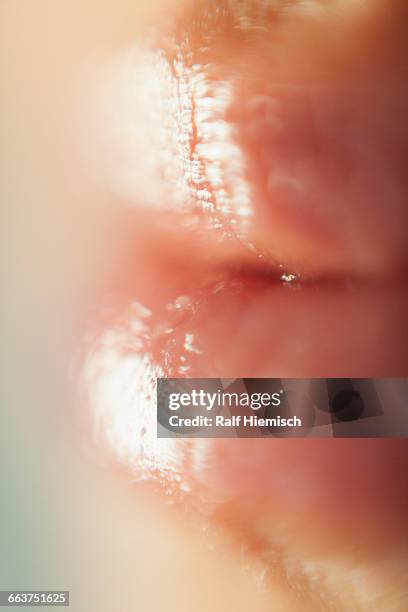 extreme close-up of womans wet lips - damp lips stock-fotos und bilder