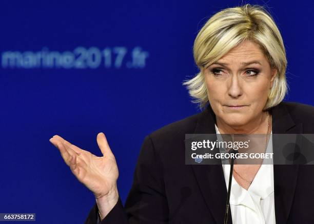 French presidential election candidate for the far-right Front National party Marine Le Pen gestures as she gives a speech during a campaign meeting...