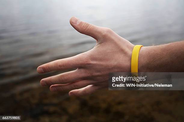 close-up of a person offering a hand shake - armband stock-fotos und bilder