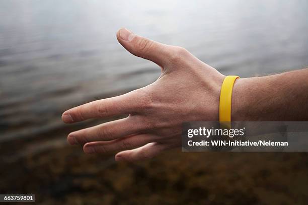 close-up of a person offering a hand shake - welcome yellow stock pictures, royalty-free photos & images