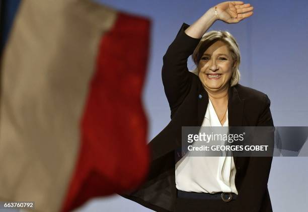 French presidential election candidate for the far-right Front National party Marine Le Pen waves as she arrives on stage to give a speech during a...