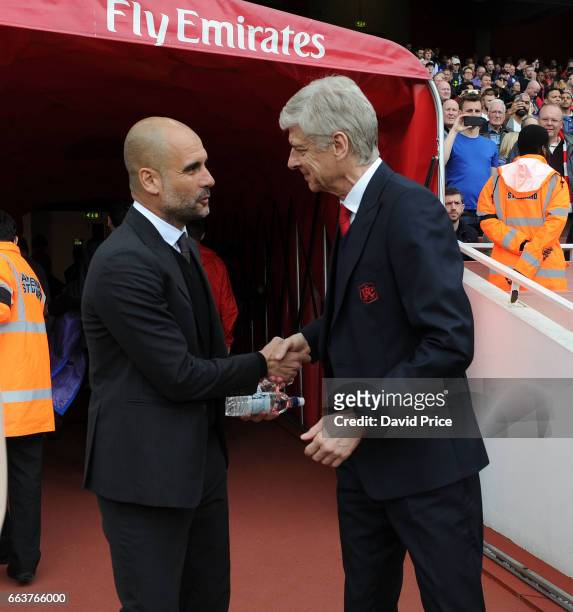 Arsene Wenger the Arsenal Manager greets Pep Guardiola of Manchester City before the Premier League match between Arsenal and Manchester City at...