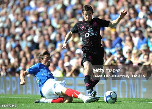 Portsmouth's Tommy Smith challenges Everton's Leighton Baines for the ball