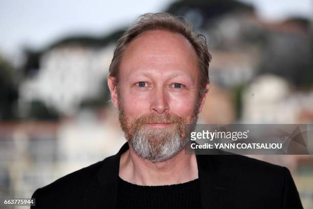 Danish actor Lars Mikkelsen, starred in the series ''Ride upon the storm", poses during a photocall as part of the MIPTV event on April 2, 2017 in...