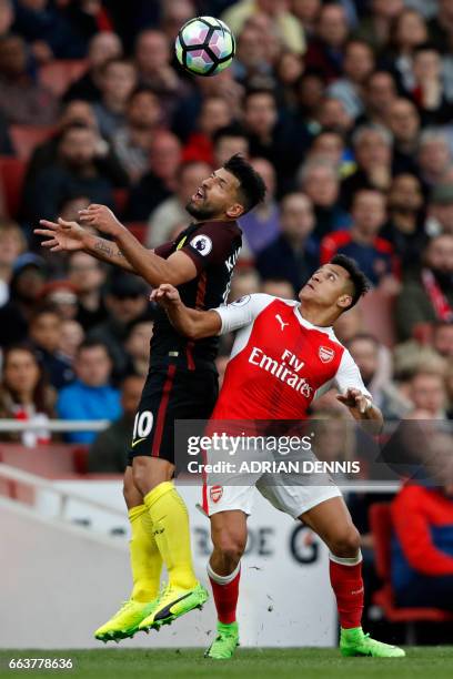 Manchester City's Argentinian striker Sergio Aguero vies with Arsenal's Chilean striker Alexis Sanchez during the English Premier League football...
