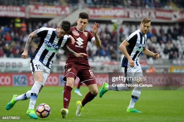 Rodrigo de Paul of Udinese Calcio and Daniele Baselli of Torino FC compete for the ball during the Serie A football match between Torino FC and...