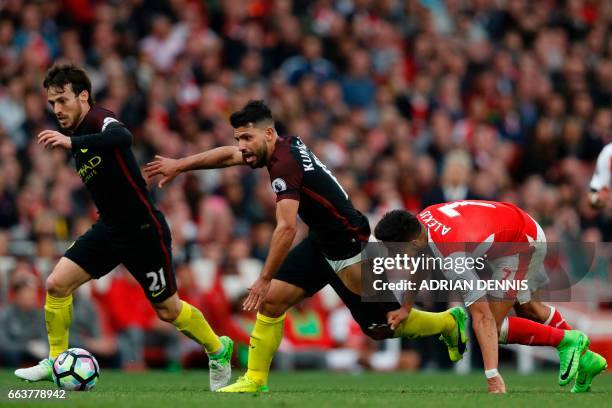 Arsenal's Chilean striker Alexis Sanchez vies with Manchester City's Argentinian striker Sergio Aguero and Manchester City's Spanish midfielder David...