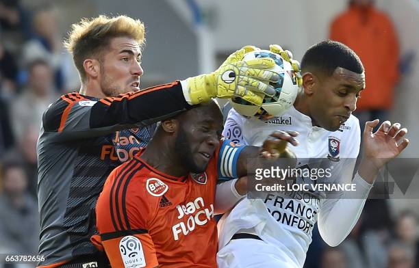 Lorient's French goalkeeper Benjamin Lecomte grabs the ball during the French L1 football match between Lorient and Caen at Moustoir Stadium in...