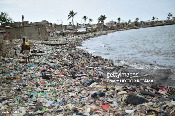 View of a beach close to the wharf in Jeremie, Haiti, on March 31, 2017. - In the background are seen houses that were damaged by Hurricane Matthew,...